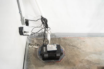 interior drainage, sump pump, and vapor barrier installed in basement
