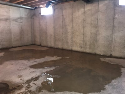Puddles of water on a basement floor.
