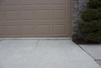 Cracked, sinking section of a driveway.