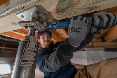 crew tightening a crawl space jack