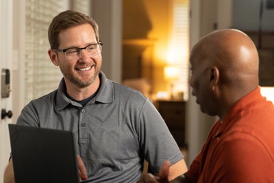 A worker conversing with a happy client.
