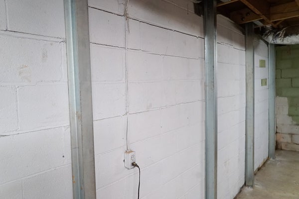 I-Beams installed along a basement wall as part of a basement waterproofing solution.