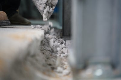 gravel pouring in basement drain trench