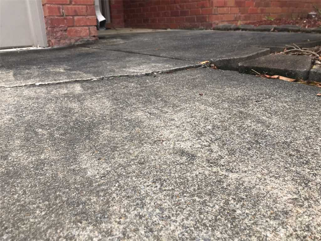 Concrete walkway that is cracked and in need of repair