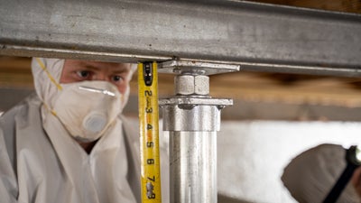CFI tech working and repairing crawl space with Crawl Space Jacks