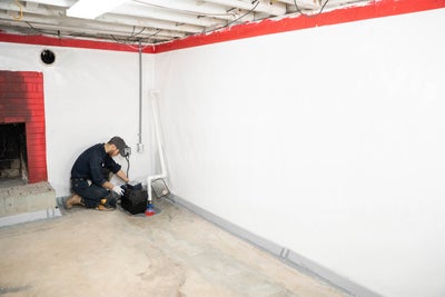 service tech installing a basement sump pump