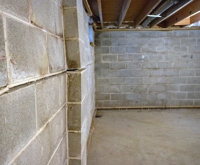 Bricks in a basement bowing inward which is a sign that the walls need to be reinforced.