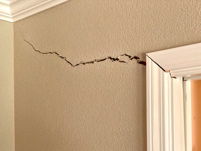 Crack in drywall near door frame.