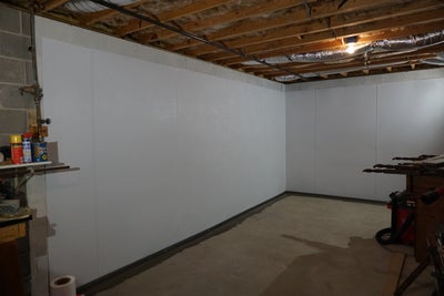 Vapor barrier completely installed along basement walls.