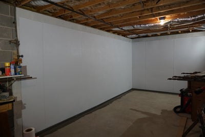 Vapor barrier completely installed along basement walls.