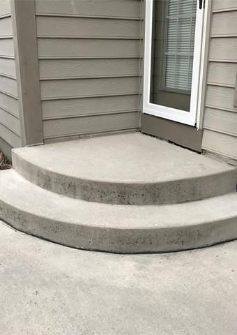 Concrete front steps outside of a home