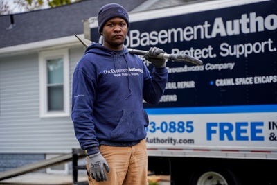 Ohio Basement Authority certified field inspector measuring a crawl space vent.