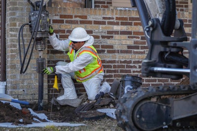 crew installing helical piers