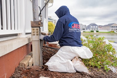 JES technician installing a foundation pier.