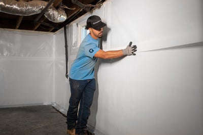 Groundworks crewman installing a vapor barrier.
