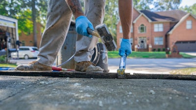 crew member applying concrete repair measures