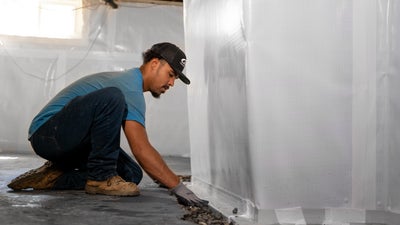 waterproofing a basement with interior drainage and a wall vapor barrier