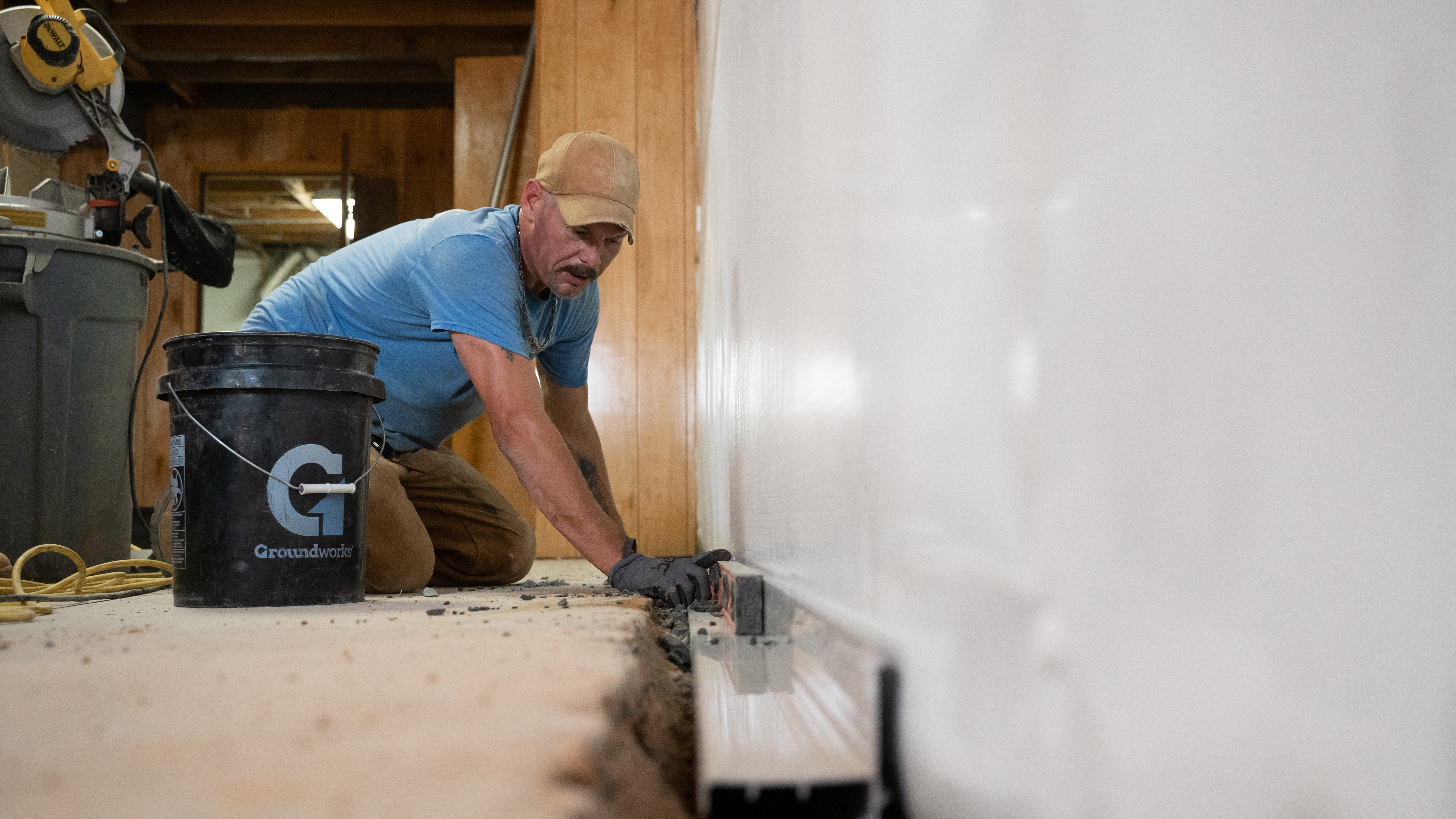 Installing interior drainage system inside a basement.