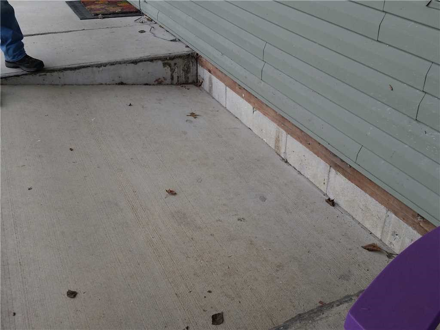 concrete lifting of patio outside of a house