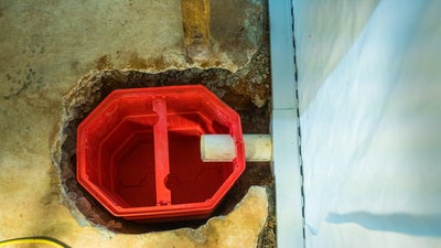 installing interior drainage and a sump pump in a basement