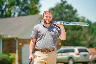 AFS inspector posing with leveling tool.
