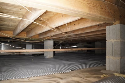 crawl space with wooden beams rim joists drainage matting