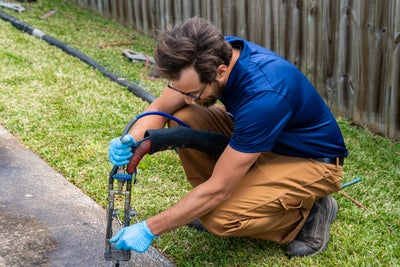 crew installing polyurethane injections for sidewalk repair