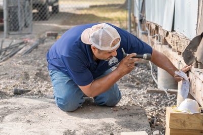 foundation inspector checking exterior walls