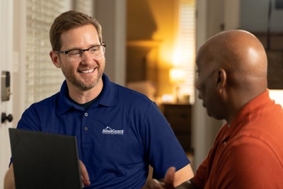 AquaGuard inspector meeting with a homeowner