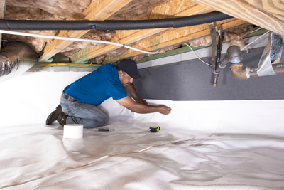 Groundworks tech working in crawl space of a home