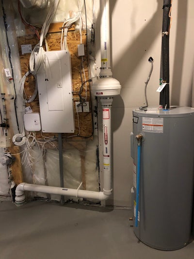 Radon mitigation system installed in a home next to the furnace to decrease their radon level