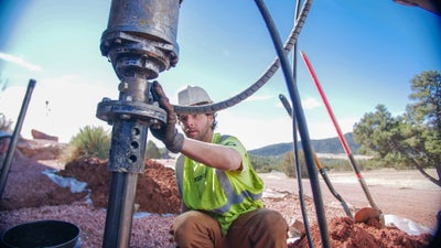 A worker repairing a foundation to stabilize a home.