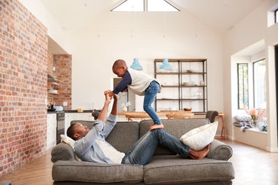 A child and father playing in a house with improved air quality.