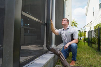 man inspecting gutters