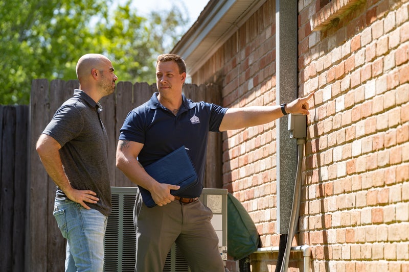 FSS inspector showing customer a cracked wall