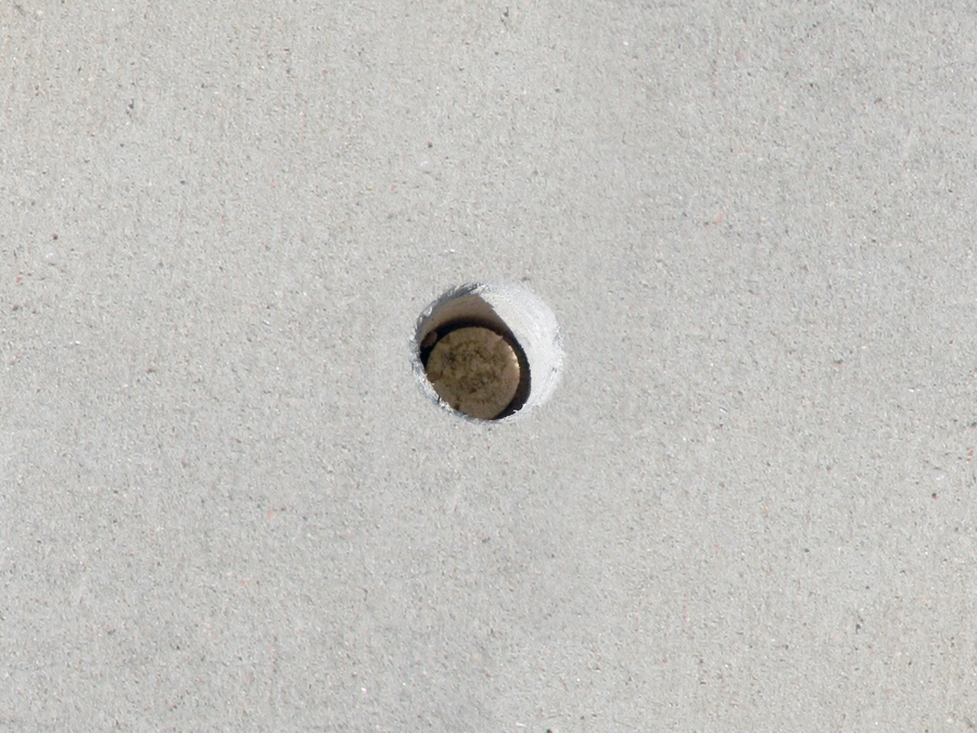 Penny sized hole in concrete as Groundworks repairs lifting concrete