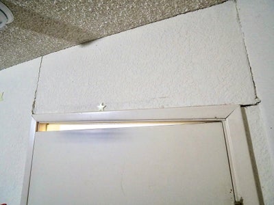 Door out of line with its frame because of foundation settlement.
