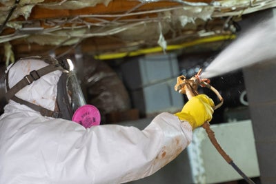 crew applying mold soda blasting technique in a crawl space