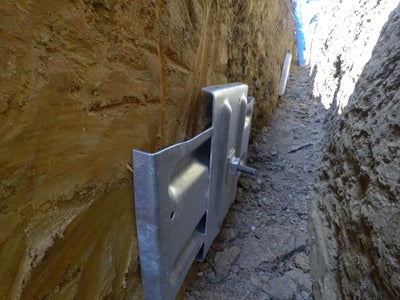 earth anchors embedded in soil as part of a wall anchor system