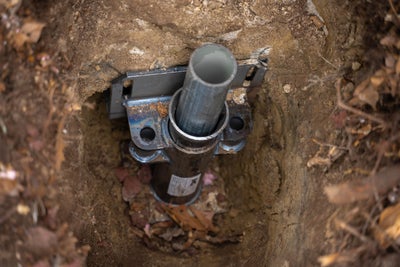 Push pier attached to a home's foundation to provide proper slab foundation repair.