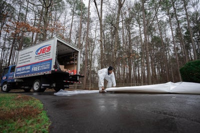 JES work truck and crew member with vapor barrier roll