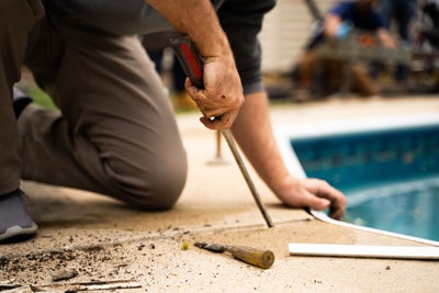 Man checking a concrete joint.
