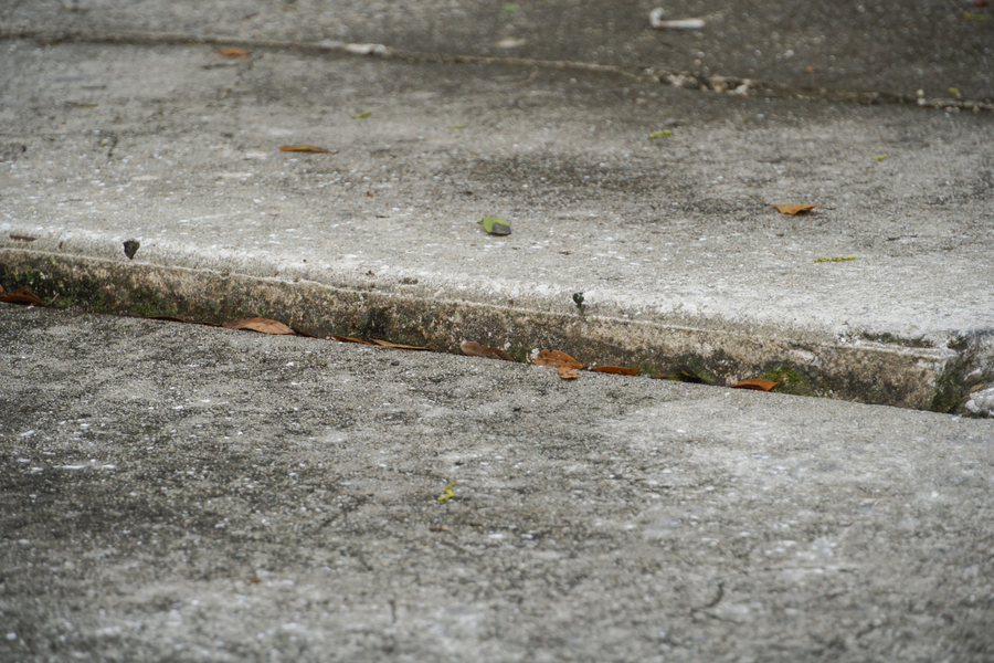 Concrete steps lifting from porch