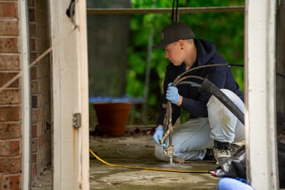 crew member fixing concrete patio slab
