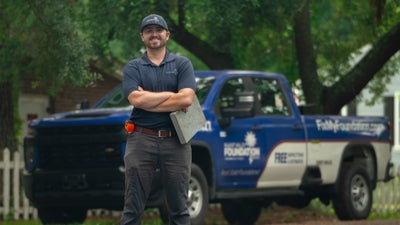 Mount Valley crewmember smiling in front of truck.