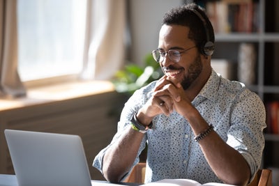 A man looking at a computer screen working