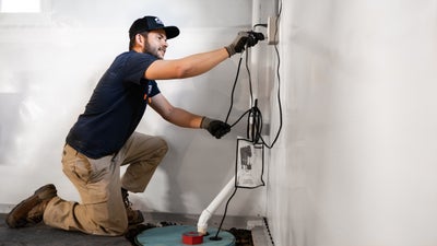 JES crew installing basement sump pump