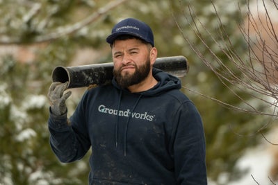 Groundworks employee working in the snow to repair your home.