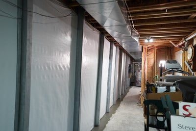 wall vapor barrier and wall beams installed in basement