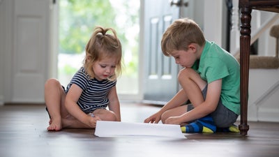 boy and girl on the floor reading